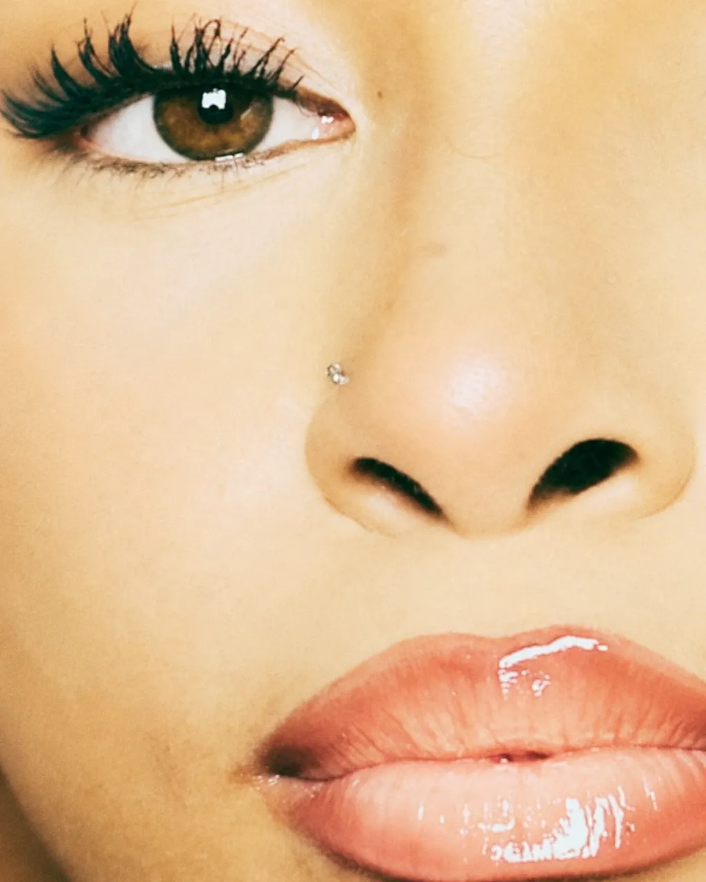 Beauty application close-up showing an eye and glossy lips